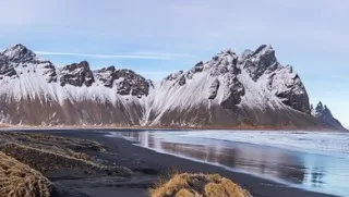 We'll take a 4-mile loop walk on the beach below Vestrahorn mountain and visit a replica Viking Village as well. 