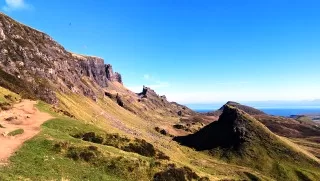 Harmonize with nature's energy while hiking The Quiraing on the Isle of Skye.